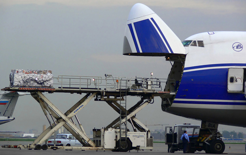 A freighter with its nose cargo door open and a loading platform at Sheremetyevo Airport